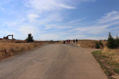 Paved North Access Lane transitions to Pipeline Lane – natural surface trail with loose gravel